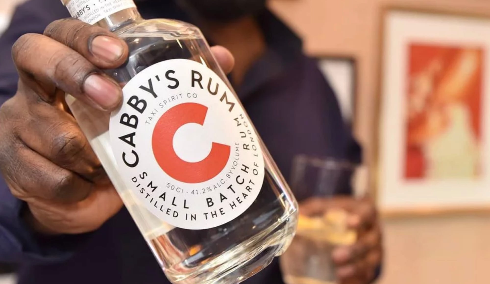 Cabby's Rum bottle in hand
